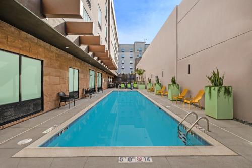 a swimming pool on the side of a building at Home2 Suites By Hilton Riverside Downtown in Riverside
