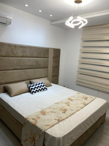 a bedroom with a large bed in a room at Lux app ain zaghouen in Tunis