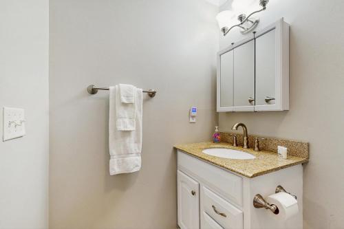 a bathroom with a sink and a mirror at Cloud Nine Mountain Home in Sugar Mountain