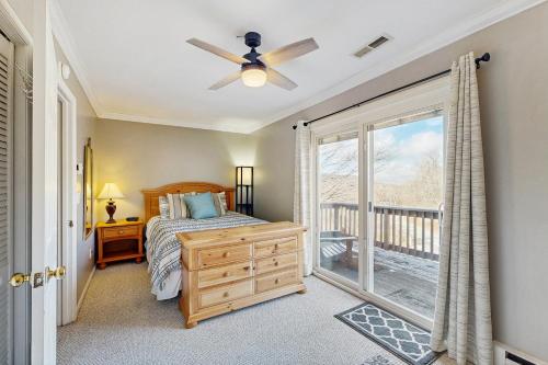 a bedroom with a bed and a window with a balcony at Cloud Nine Mountain Home in Sugar Mountain