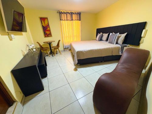 a bedroom with a bed and a table and chairs at Hostal Mayra Breña in Lima
