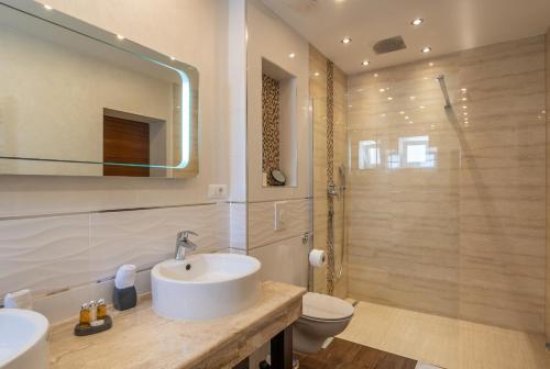 a bathroom with a sink and a toilet at Villa Višnja in Brela