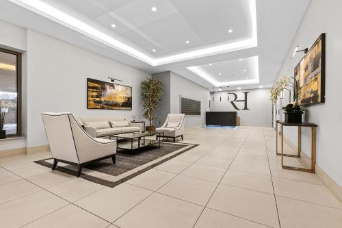 a lobby with chairs and a couch and a table at Lux City Centre,Parking on Request,Riverside,Wifi,Netflix,2BD-ensuite,Bosch Coffee Machine in York