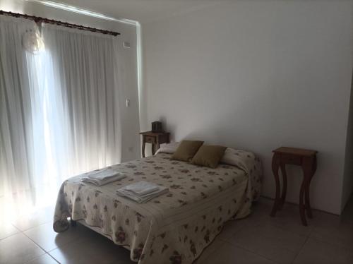 a bedroom with a bed and a window at Casa en Ataliva Roca in Ataliva Roca