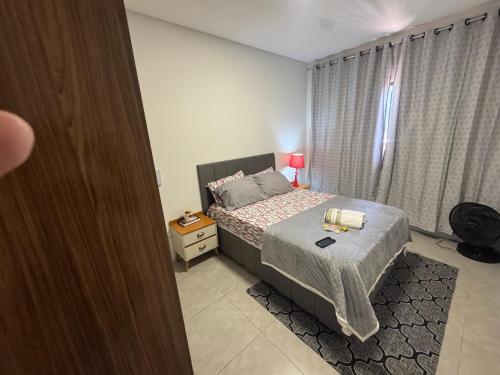 a small bedroom with a bed and a window at Casa Nova & Aconchegante in São Bento do Sul