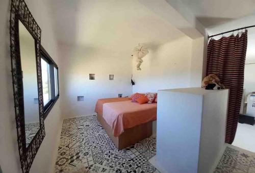a bedroom with a bed and a mirror at Dar-west in Demina