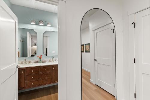 a bathroom with two sinks and a large mirror at The Optimist Guesthouse | 5 in Camden