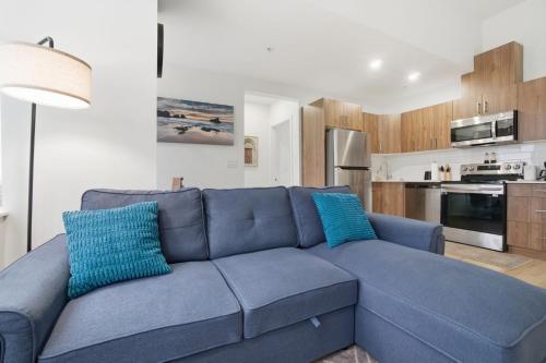 a blue couch with two blue pillows in a living room at Luxury 1Beds and 2Beds in Downtown Edmonton close to Rogers in Edmonton