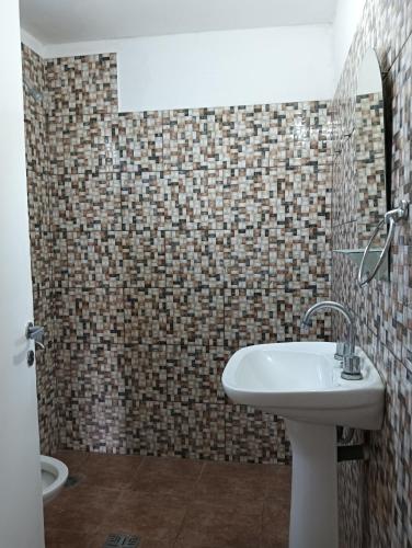 a bathroom with a sink and a toilet at Los Talitas in Villa Parque Siquiman