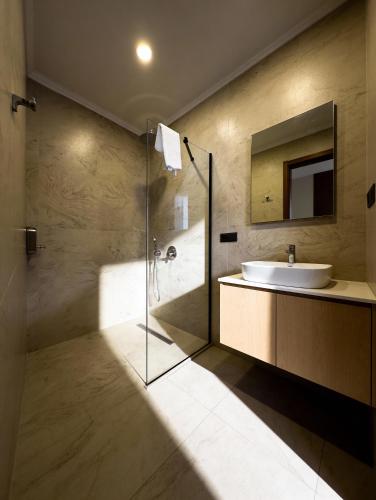 a bathroom with a sink and a shower and a mirror at InOut Social in Fethiye