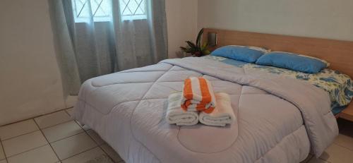 a bedroom with a bed with towels on it at Villas De Morne in Castries