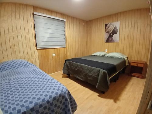 a bedroom with a bed and a window at Casa Entre Cerros in Futrono