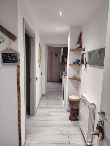 a hallway with a tile floor in a house at Lika in Livigno