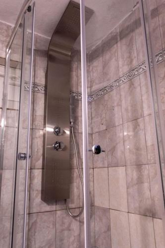 a shower with a glass door in a bathroom at Patty's House Kallikratia in Vergia