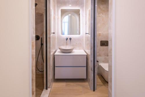 a bathroom with a sink and a mirror at Promenade Chios Port Residences in Chios