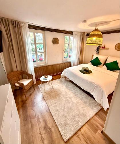 a bedroom with a large bed and a chandelier at Historisches Fachwerk Haus am Fluss in Monschau