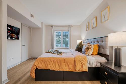 a bedroom with a large bed and a window at Luxury Jacuzzi Suite with Sauna & Heated Pool in Shanty Bay