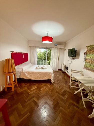 a bedroom with a bed and a large window at Spacious Studio in Alsina in Salta