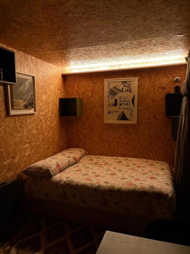 a small bedroom with a bed and pictures on the wall at The 9 acre in Midleton