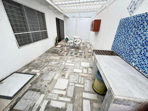a room with a table and a blue and white tile floor at Casa Lucy Alojamientos in Palmira