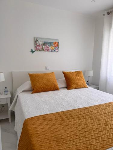 a bedroom with a large bed with orange pillows at Casa Ventura in Lagos