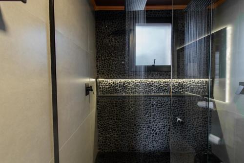 ein Badezimmer mit Glasdusche und Fenster in der Unterkunft Piemonte chalé in Casca