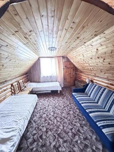 a room with two beds in a log cabin at Anetes pirts in Jaunanna