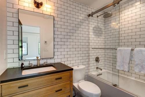 a bathroom with a sink and a toilet and a mirror at Abode at Rendezvous in Teton Village