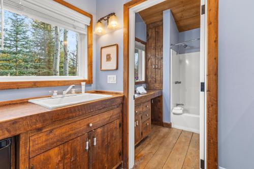 a bathroom with a sink and a shower and a window at Abode at Alpine Retreat in Wilson