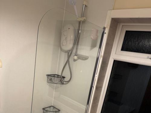 a shower with two baskets on the wall at 2 Borrodale - Sleeps 4 & Beautiful Mountain View in Glendale
