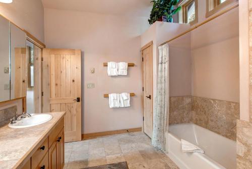 a bathroom with a tub and a sink at Abode at Moose Creek #21 in Teton Village