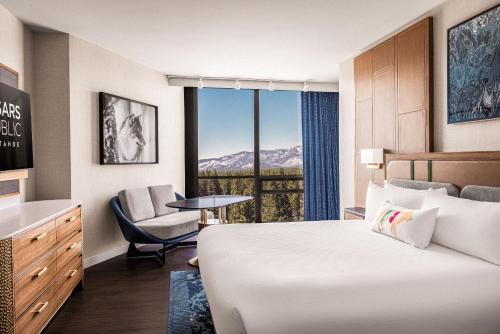 a hotel room with a bed and a chair and a window at Caesars Republic Lake Tahoe, A Caesars Destination in Stateline