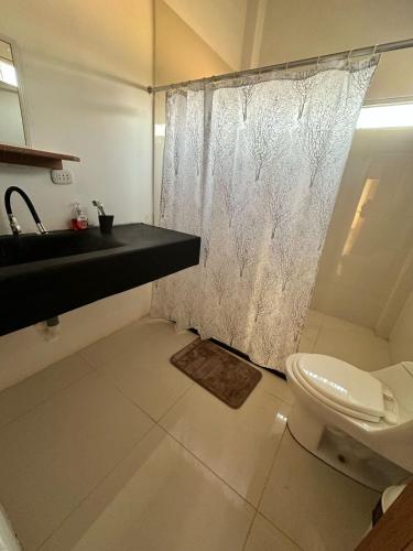 a bathroom with a sink and a toilet at Casa Vichayito - Los Órganos in Los Órganos