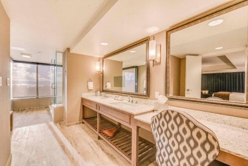 a bathroom with two sinks and a large mirror at Caesars Republic Lake Tahoe, A Caesars Destination in Stateline