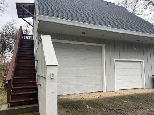 a garage with a door and a staircase next to it at Montgomery Apartment in Redding