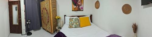 a room with a bed with two pillows on it at Carribean Boutique Hostel in San José