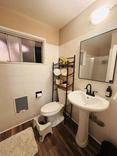 a bathroom with a toilet and a sink at Stunning Oasis with Pool by Disneyland and Knotts in Buena Park
