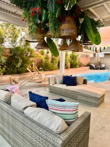 a patio with two wicker couches and a pool at Stunning Oasis with Pool by Disneyland and Knotts in Buena Park