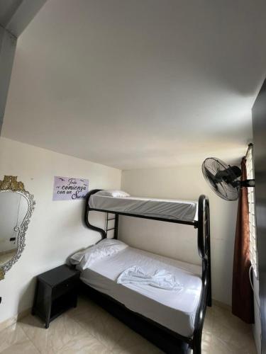 a small room with two bunk beds in it at Suite María Paula in Colombia