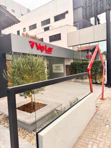 a view of a vodafone store from the street at Pousada Vivenza - Suíte Super Confort 01 in Laguna