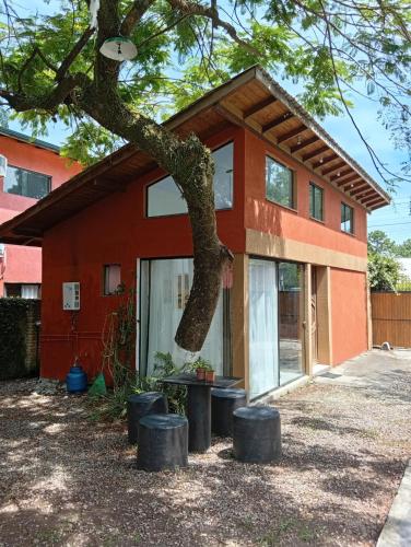 a house with a tree in front of it at Casa com spa hidromassagem in Florianópolis