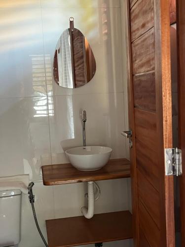a bathroom with a sink and a mirror at Pousada Paracuru Surf in Paracuru
