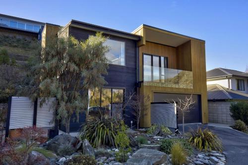 a contemporary house with a yellow at Shotover View - Family friendly close to Coronet Peak in Frankton Wharf