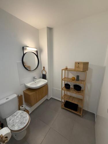 a bathroom with a toilet and a sink and a mirror at Villa Lissya in Morne-à-lʼEau