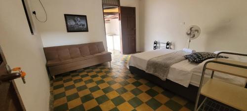 a bedroom with a bed and a checkered floor at La Ermita apto in Roldanillo