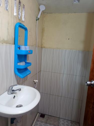 a bathroom with a sink and a mirror on the wall at Heiner Beach Homestay in Bunaken