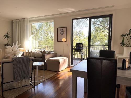 a living room with a couch and a table at Villa Croissant 2br located within Cypress Lakes Resort in Pokolbin