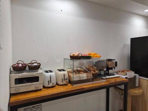 a counter with a microwave and some food on it at Haeundae HaeRium Hotel in Busan