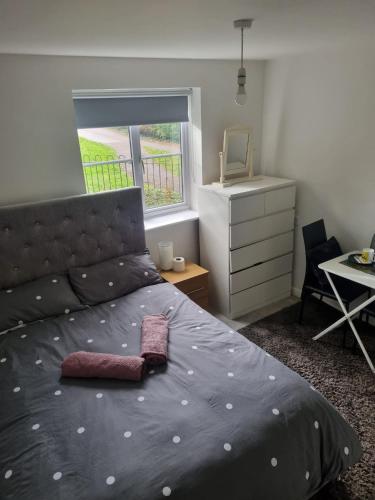 a bedroom with a bed and a desk and a window at The Pringle Inn in Great Baddow
