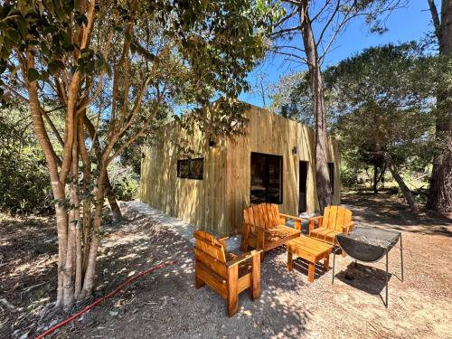 a couple of chairs and a table and a building at Refugio del Mar 3 in Ocean Park